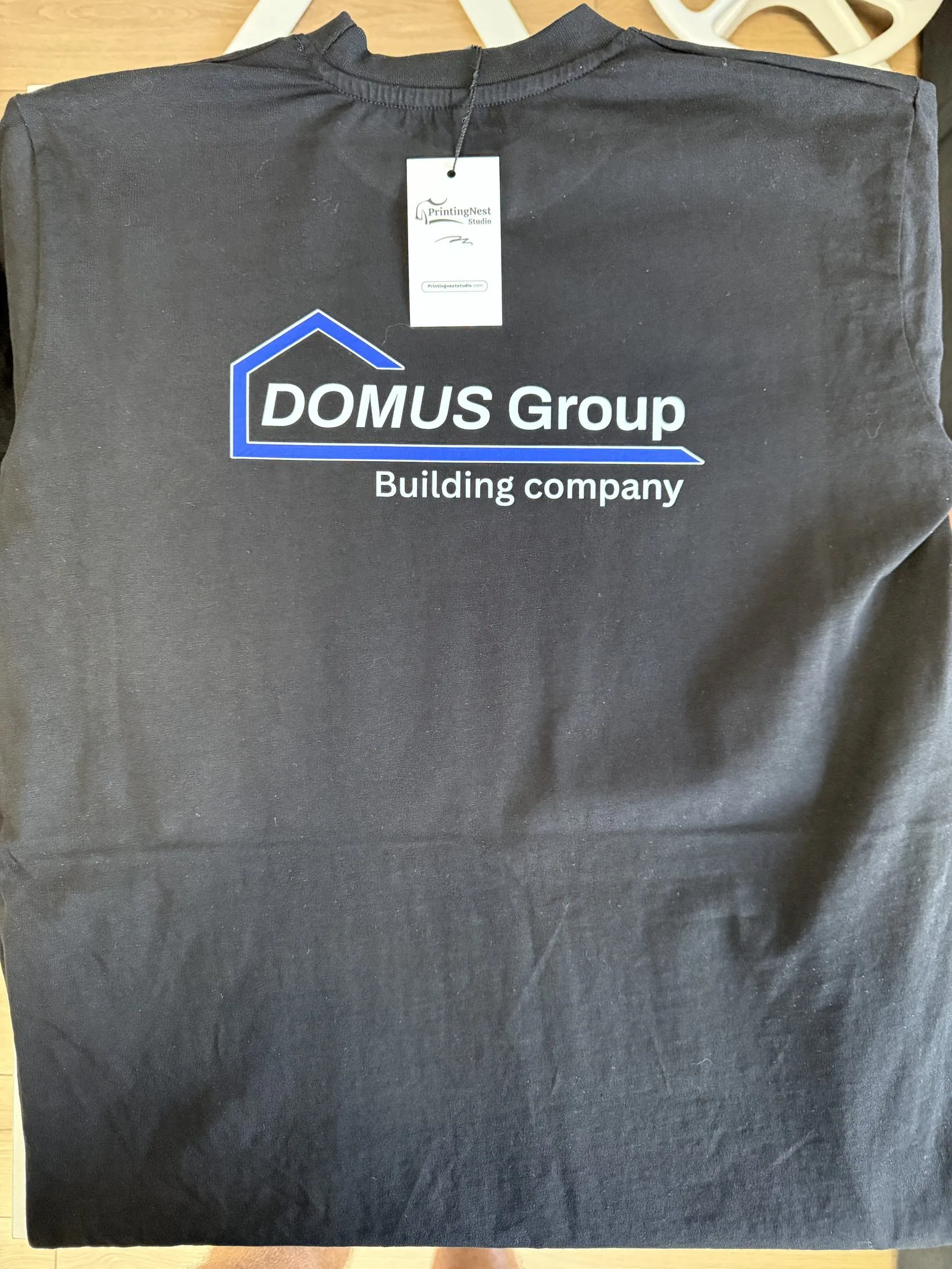 Black T-shirt with white and blue DOMUS Group print